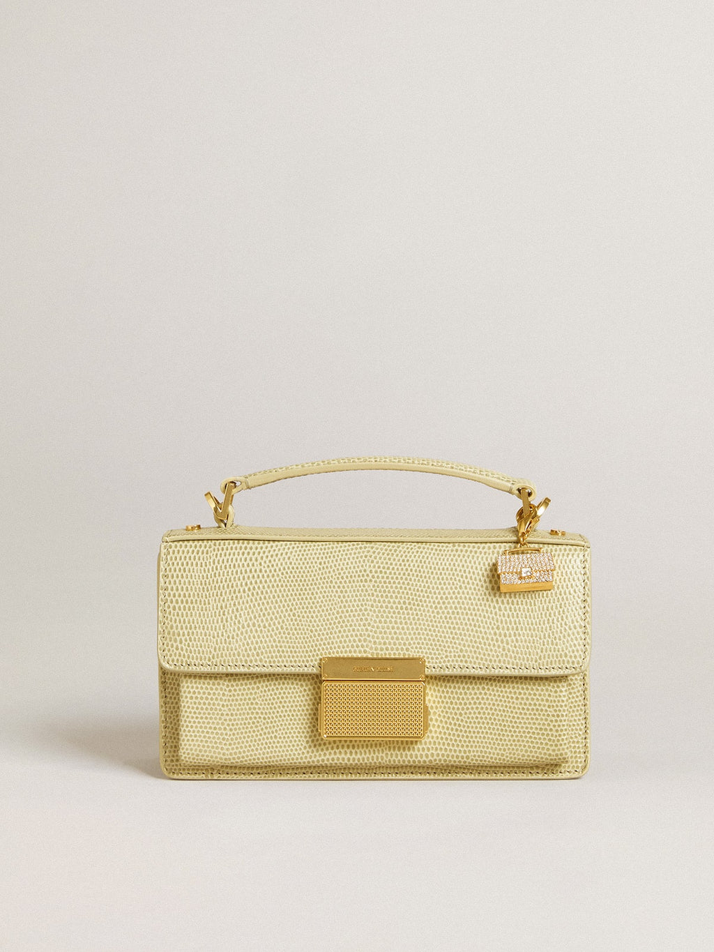 Purse-shaped charm in gold-colored brass with crystals