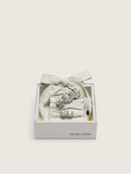 Skins "Sparkling" cream and silver herringbone laces embellished with two charms
