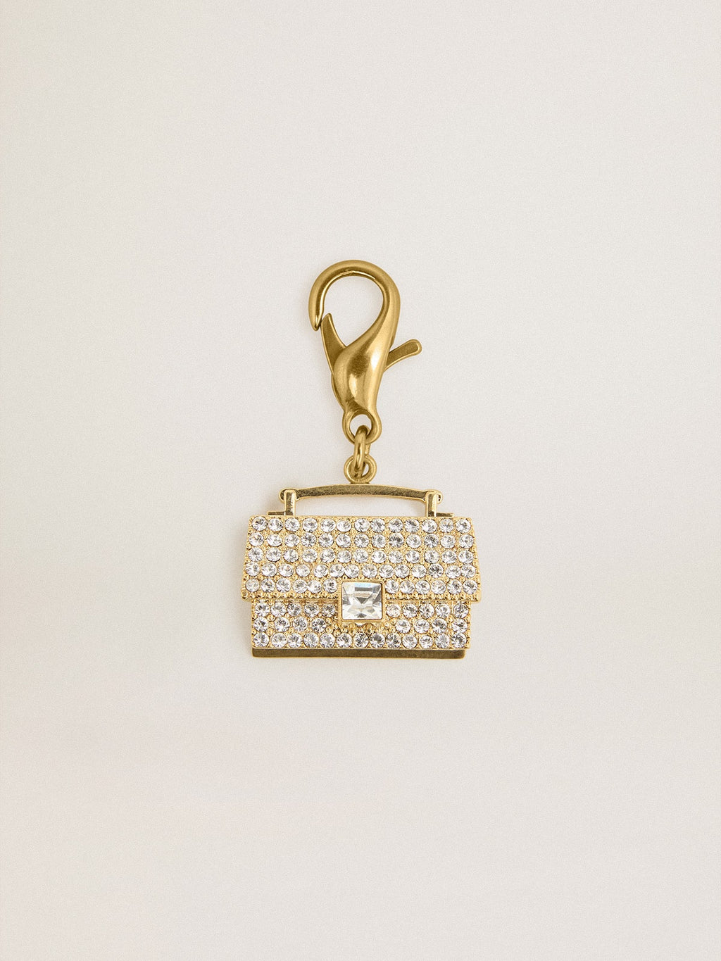 Purse-shaped charm in gold-colored brass with crystals