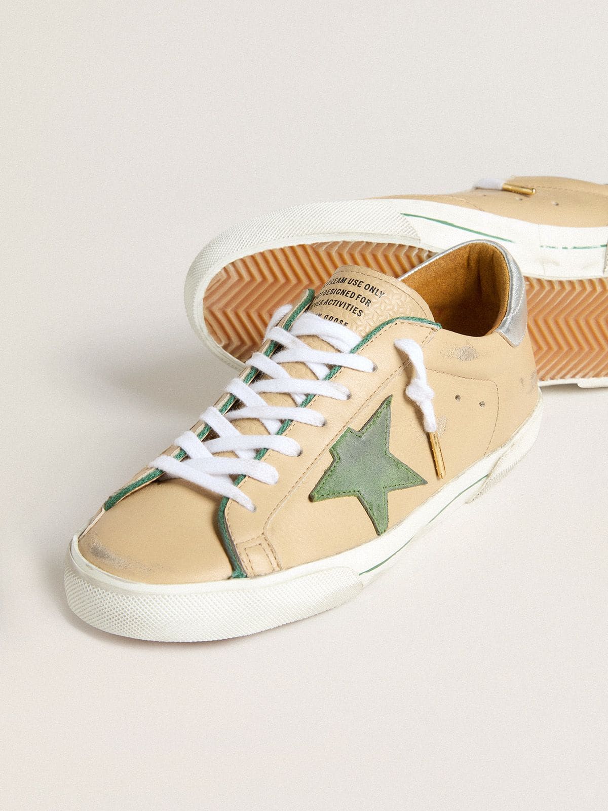 Super-Star LTD in beige leather with green suede star and silver foiled leather heel tab