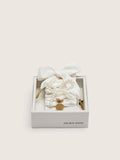 Skins "Sparkling" cream striped laces embellished with beaded charm and golden charm