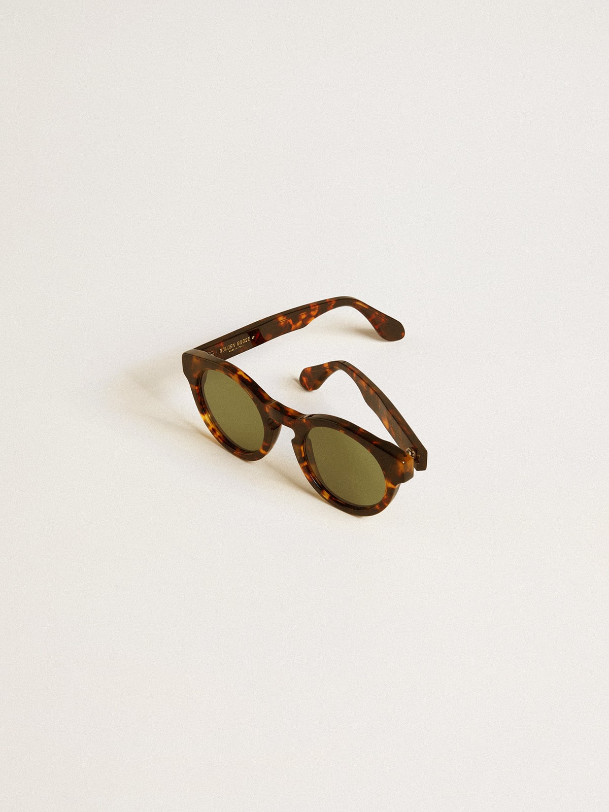 Square style Panthos sunglasses with havana brown frame and green lenses
